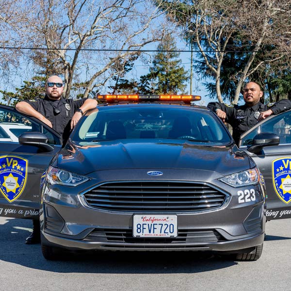 security professionasl by patrol car