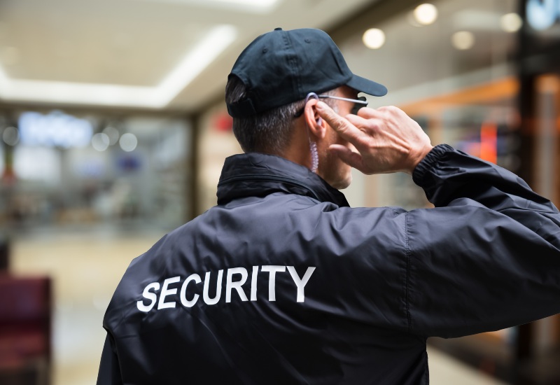 A retail security guard in San Jose, CA, talking on his cell phone while on duty.
